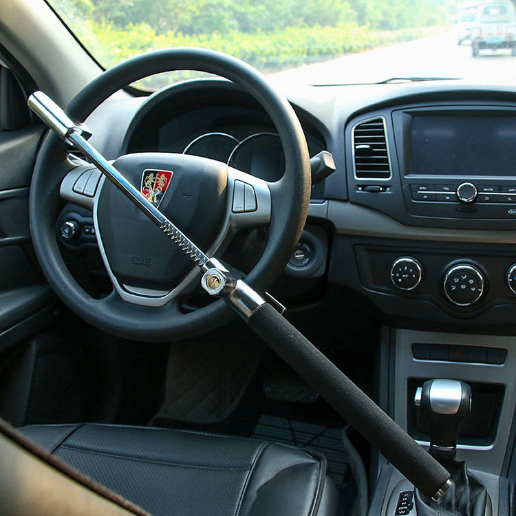 Metal anti-theft steering wheel lock installed across a car steering wheel